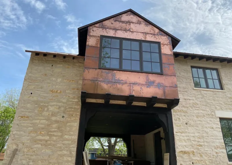 Copper metal panel facade on a stone building for Roof Repair in Gering